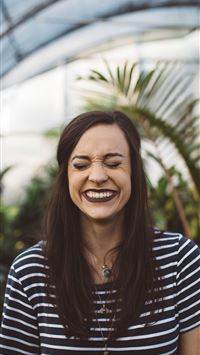 woman smiling while standing in garden wallpaper