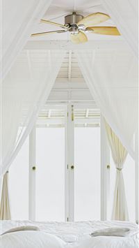 bed sheet near glass window wallpaper