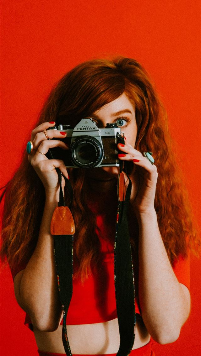 640x1136 woman in red top and bottoms holding Pentax camera -  iPhone Wallpaper