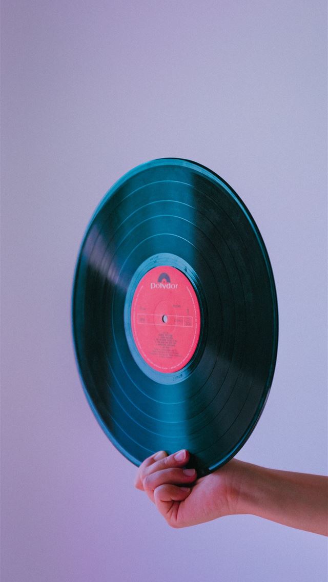 1284x2778 person holding vinyl record - portugal iPhone Wallpaper