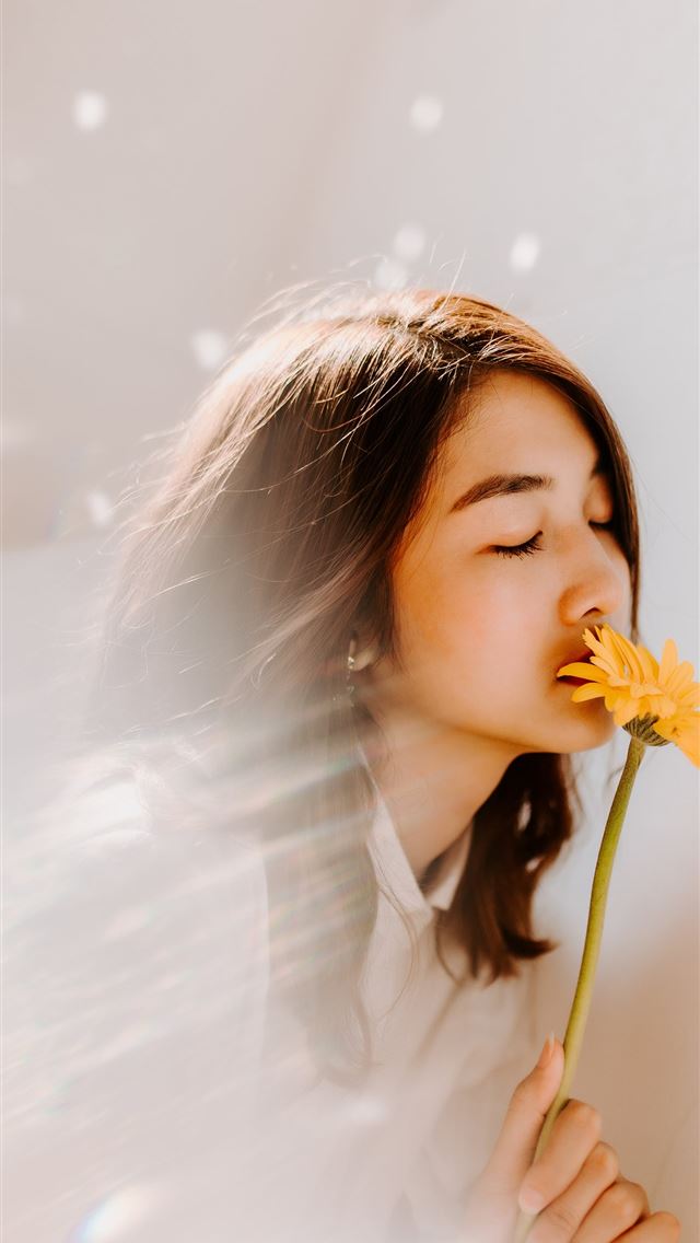 1284x2778 woman smelling on yellow flower - girls iPhone Wallpaper