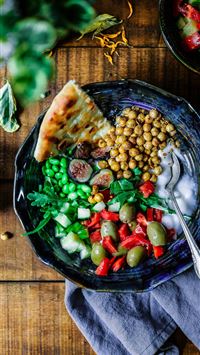 silver spoon on black ceramic bowl with vegetables wallpaper