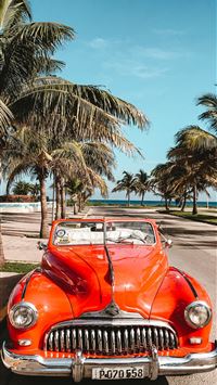orange car on asphalt road wallpaper