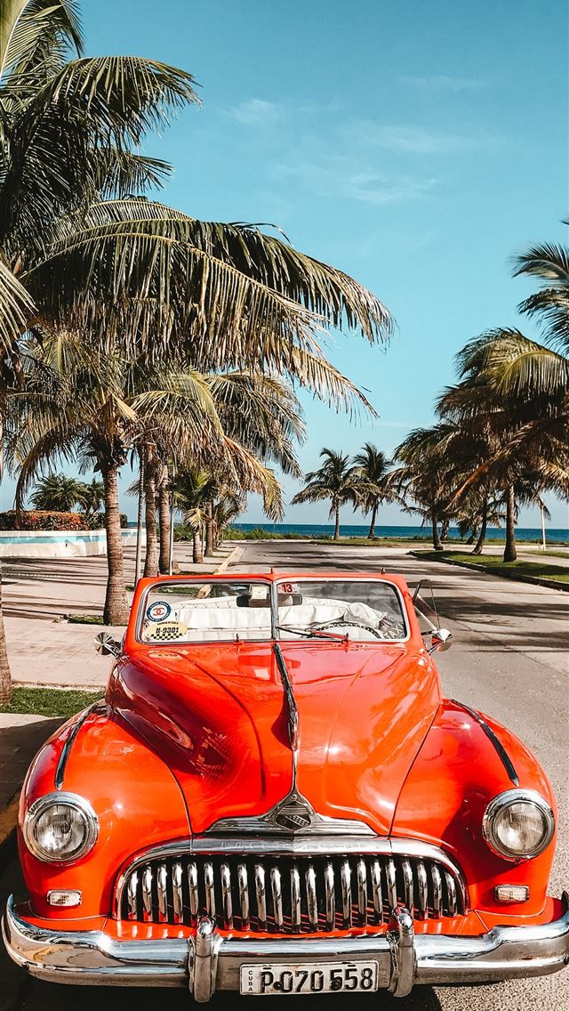 1284x2778 orange car on asphalt road - summer iPhone Wallpaper