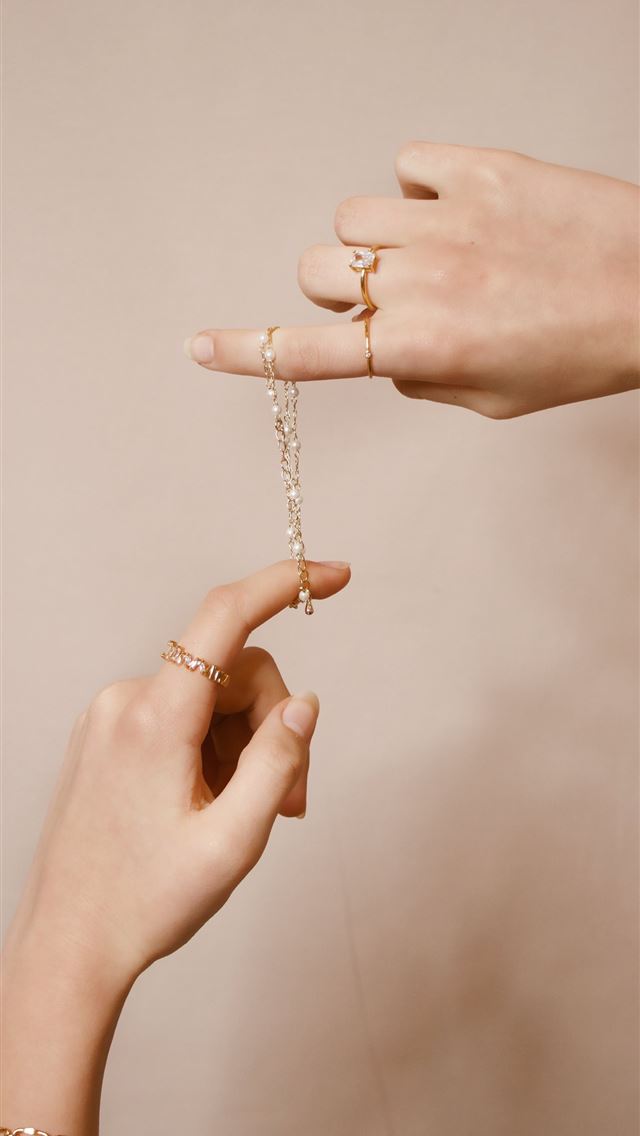 1284x2778 person holding silver chain necklace - girl iPhone Wallpaper