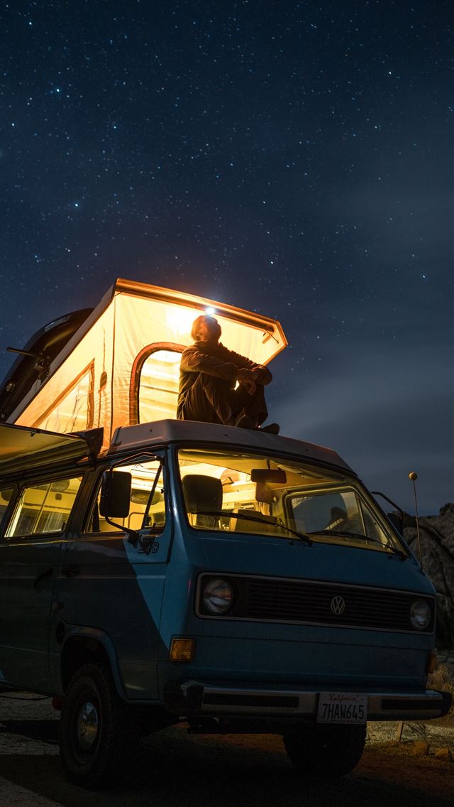 1284x2778 man sitting on top of blue van staring at sky duri... - night sky iPhone Wallpaper