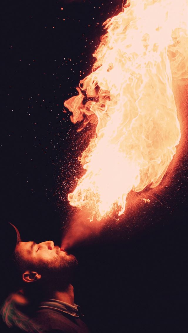 1284x2778 man blowing fire - morocco iPhone Wallpaper