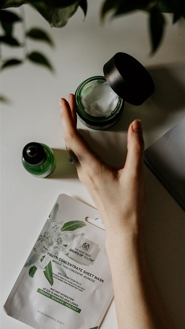 1284x2778 person touching black plastic bottle - beauty iPhone Wallpaper