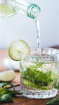 clear glass cup on brown wooden surface wallpaper