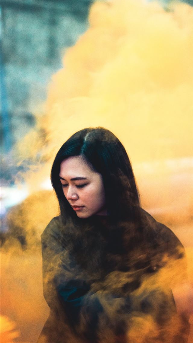 1284x2778 woman surrounded by orange smoke -  iphone 13 Wallpaper
