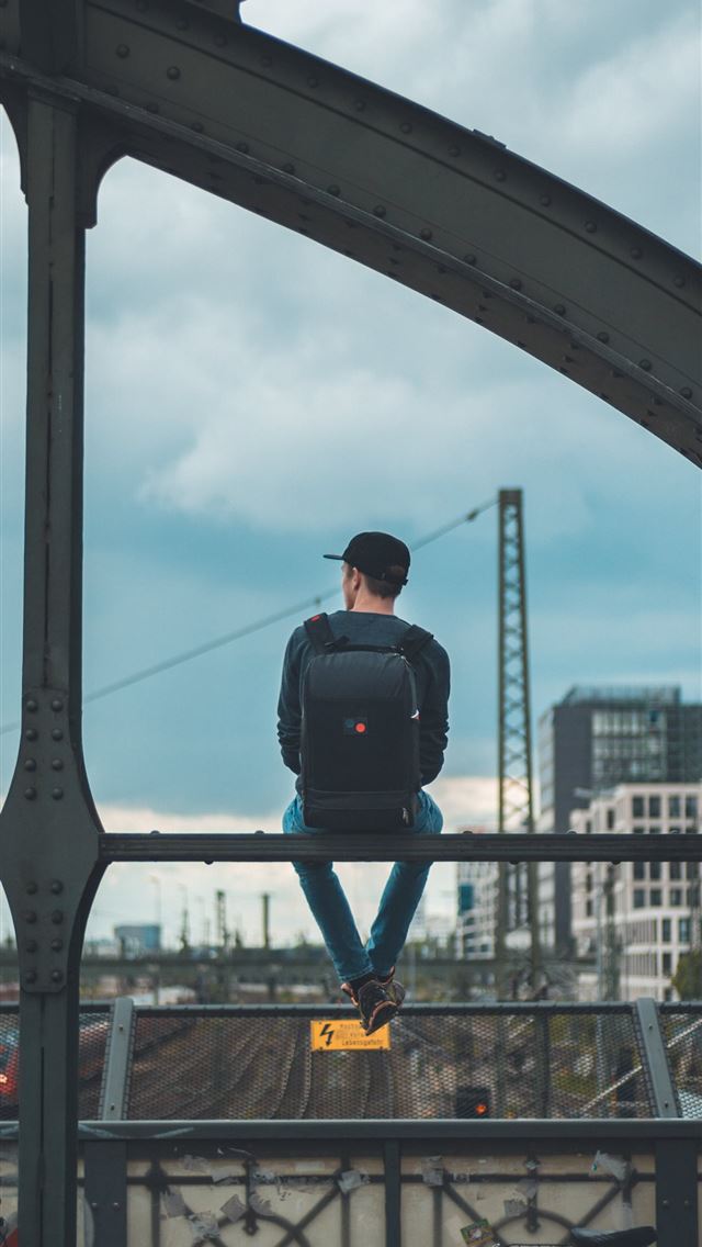 1284x2778 man sitting on top of bridge -  iphone 13 Wallpaper