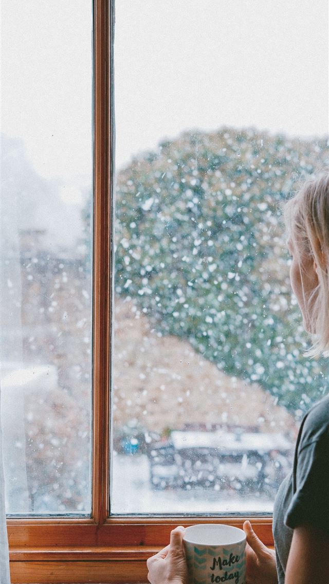 1284x2778 woman standing in front of clear glass window -  iphone 13 Wallpaper