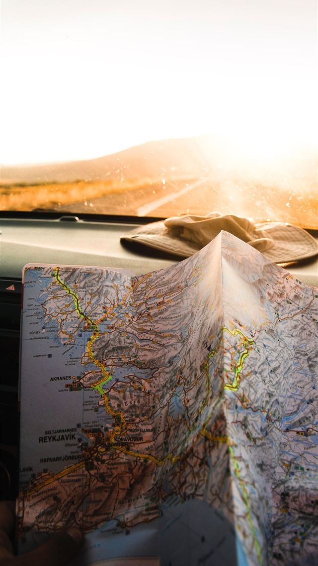 1284x2778 person holding blue and brown map - iceland iPhone Wallpaper
