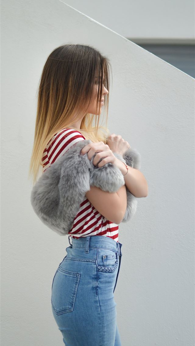 1284x2778 woman with pink fur scarf near wall - greece iPhone Wallpaper