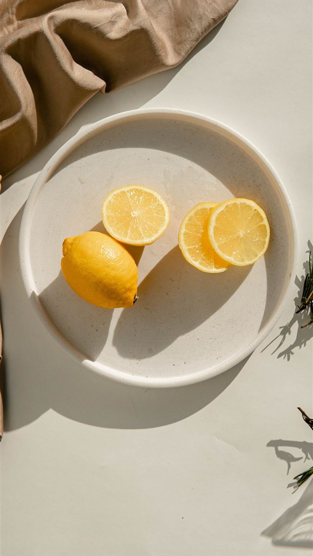 1284x2778 sliced lemon on white ceramic plate - fruit iPhone Wallpaper