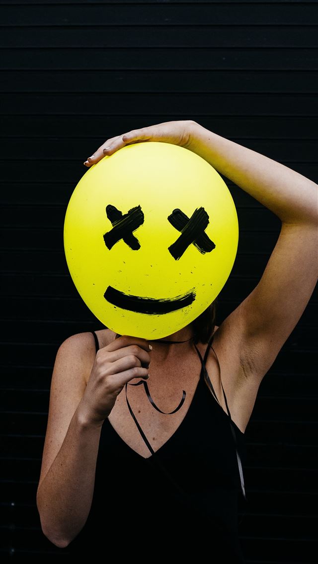 1284x2778 woman holding yellow and black balloon at daytime - yellow iPhone Wallpaper