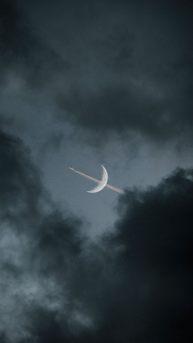 1284x2778 white airplane in mid air under gray clouds -  iphone 13 Wallpaper