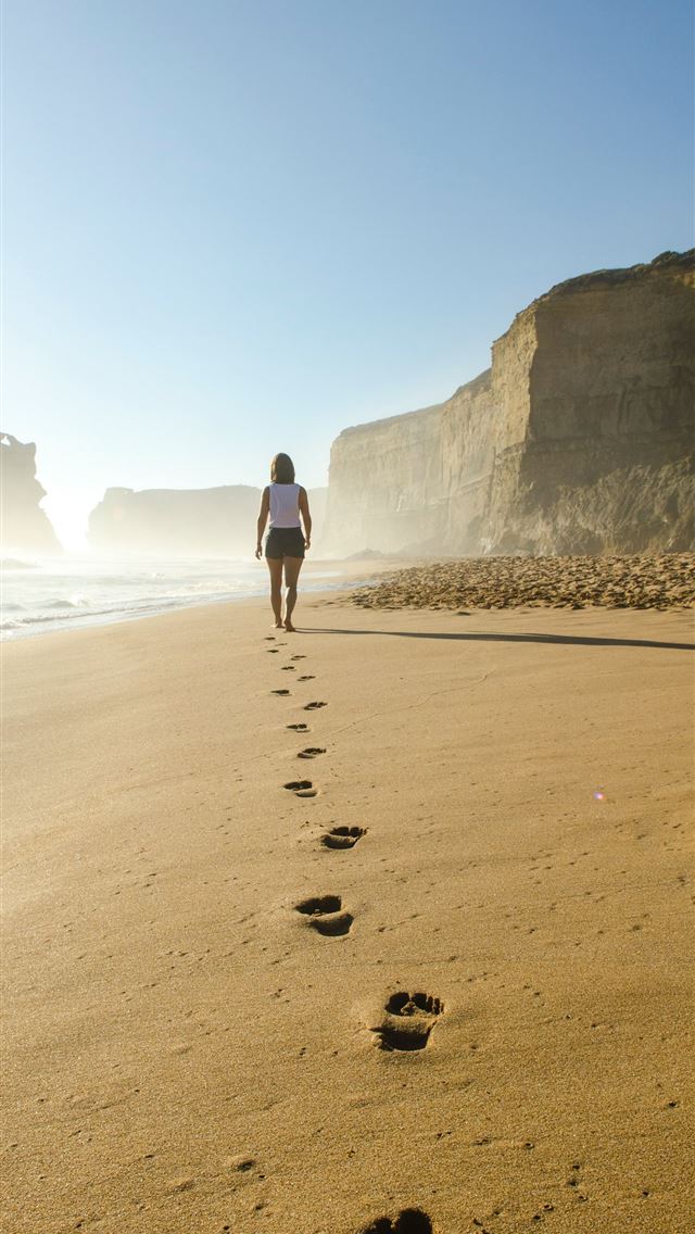 1284x2778 woman walking on shore - beach iPhone Wallpaper