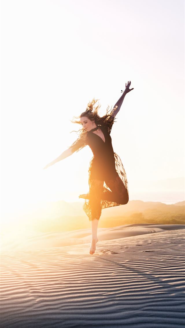 1284x2778 woman walking on desert during sunset - beautiful iPhone Wallpaper