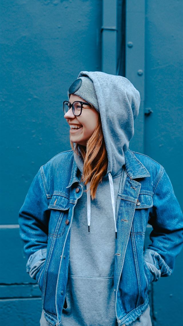 1284x2778 woman standing near blue steel gate -  iphone 13 Wallpaper
