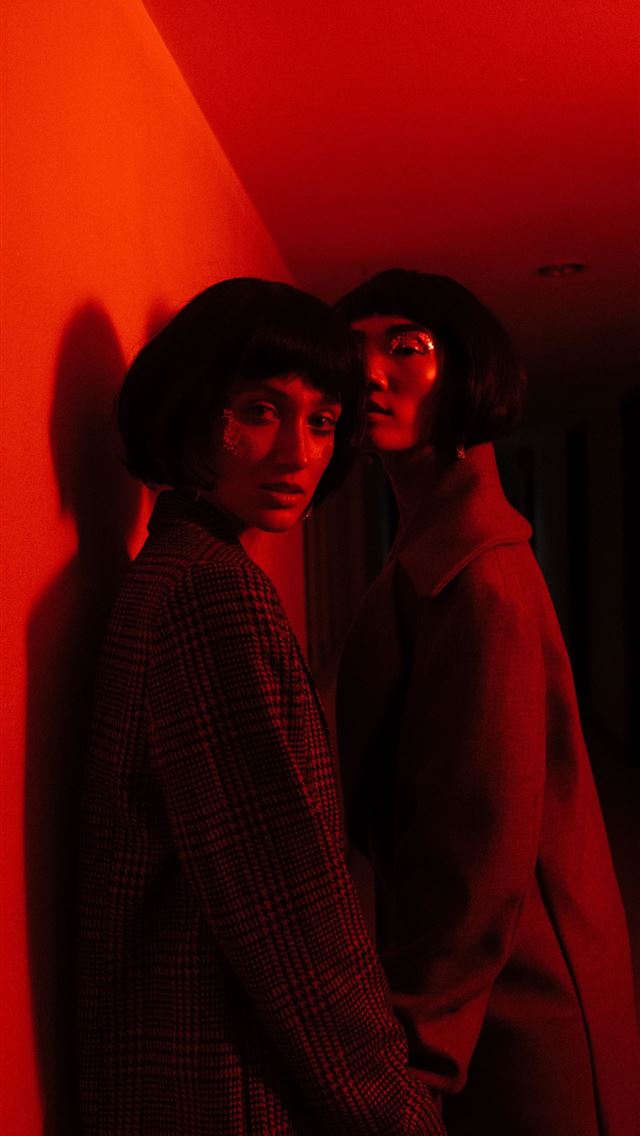 1284x2778 two woman wearing coat standing near wall - red iPhone Wallpaper