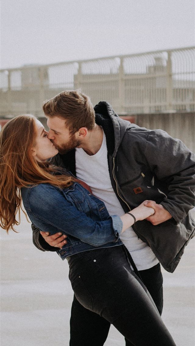 1284x2778 man kissing woman during daytime - love iPhone Wallpaper