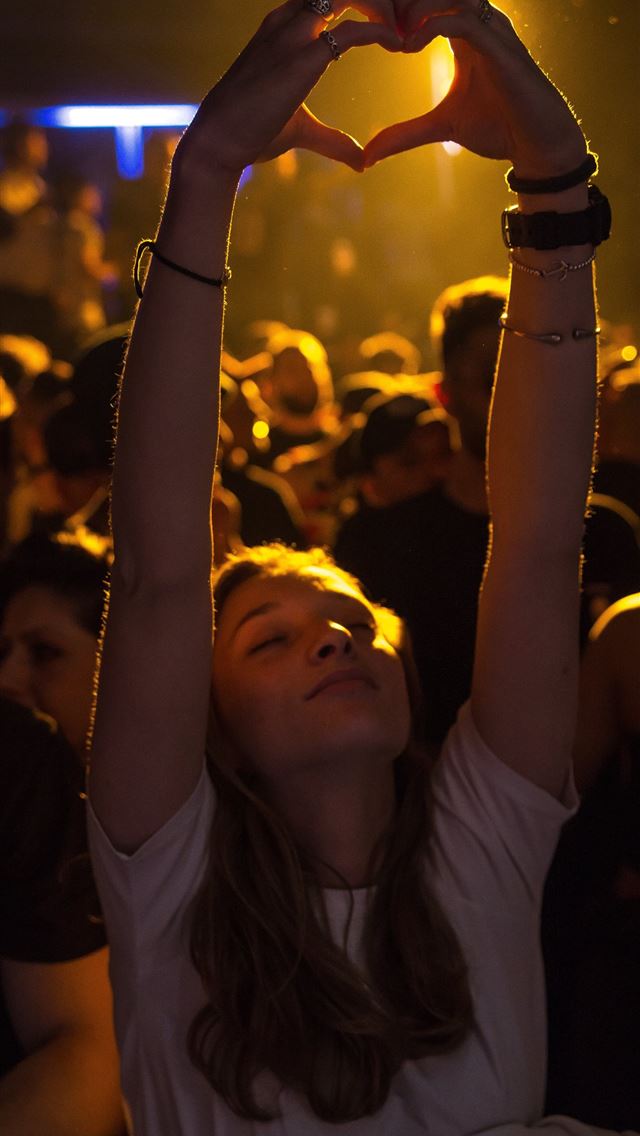 1284x2778 woman at crowd raising her hand while making heart... - italy iPhone Wallpaper