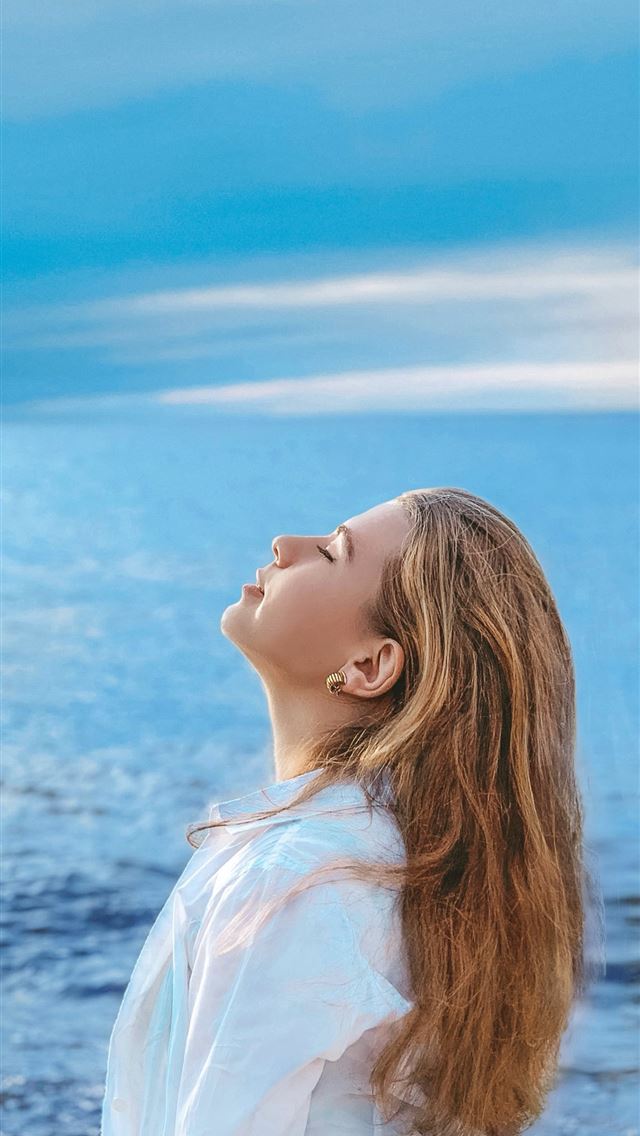 1284x2778 woman in white shirt standing near sea during dayt... - girl iPhone Wallpaper