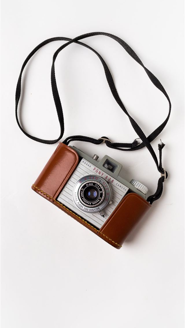 1284x2778 brown and gray SLR camera on white surface - vintage iPhone Wallpaper