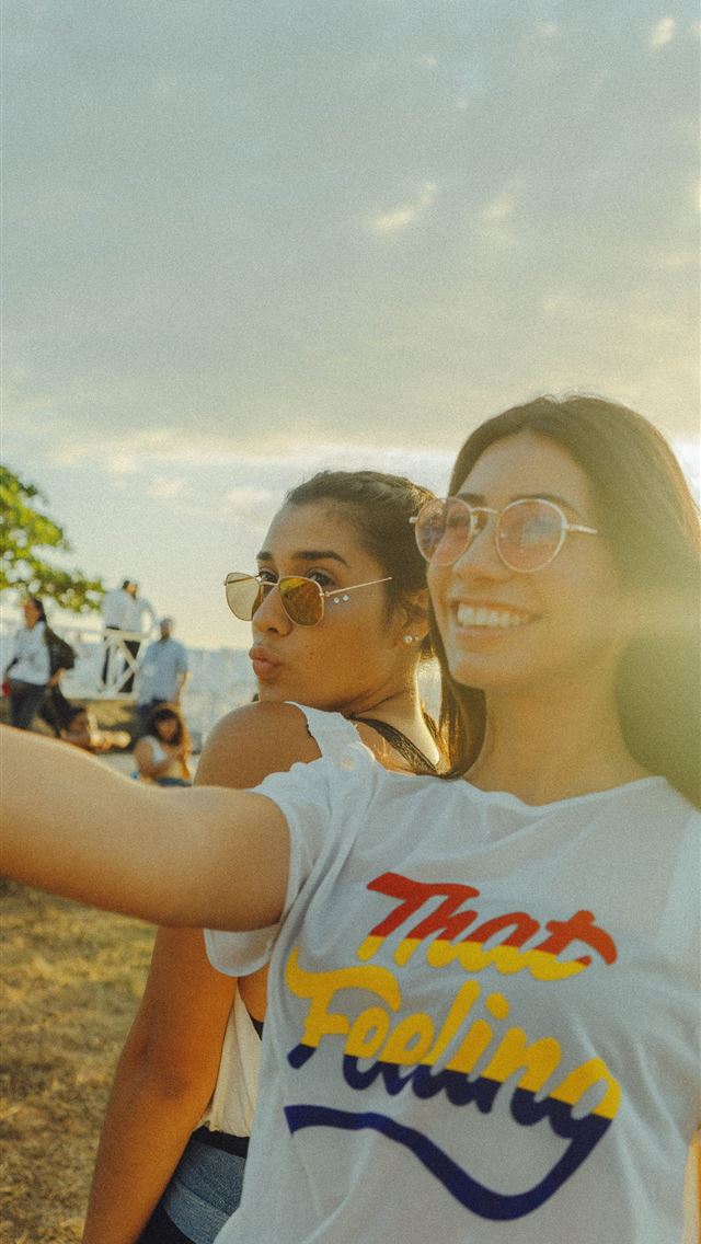 1284x2778 women taking photo near beach at daytime - santo domingo iPhone Wallpaper