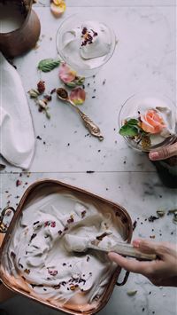 person scooping ice cream into cup wallpaper