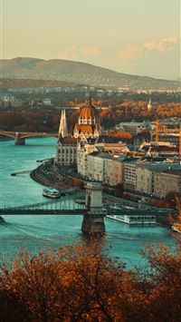 view of gray building near body of water wallpaper
