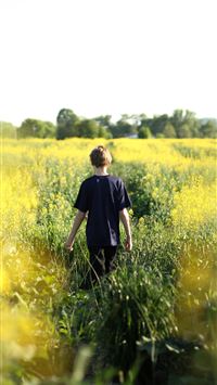 boys walking in yellow flower field during dayitme wallpaper