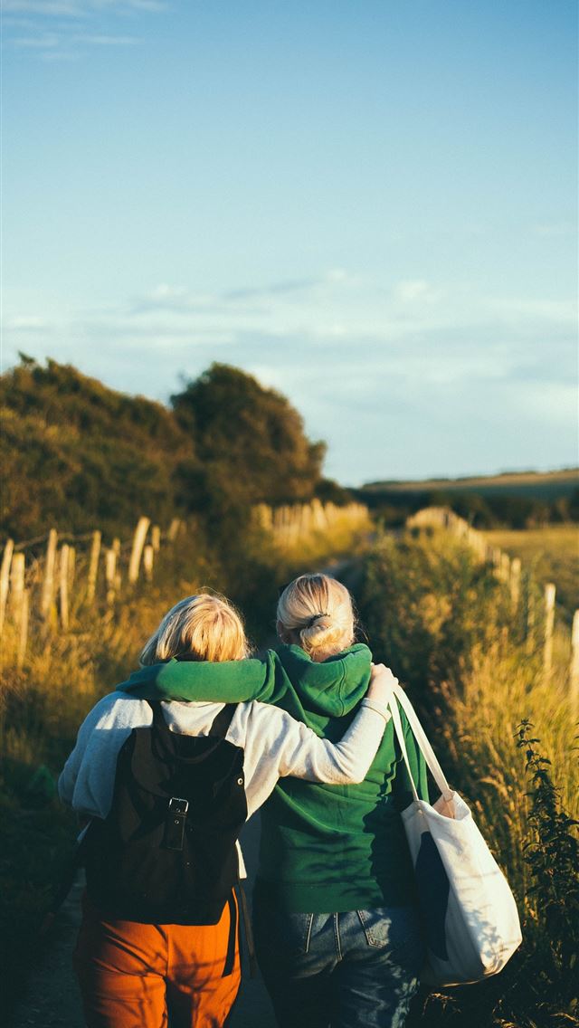1284x2778 two women walking together outdoor during daytime - united kingdom iPhone Wallpaper