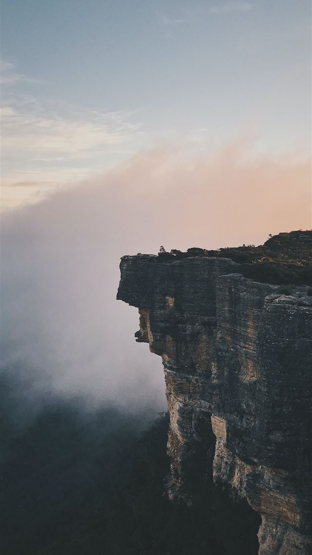 1284x2778 person sitting on mountain cliff - australia iPhone Wallpaper