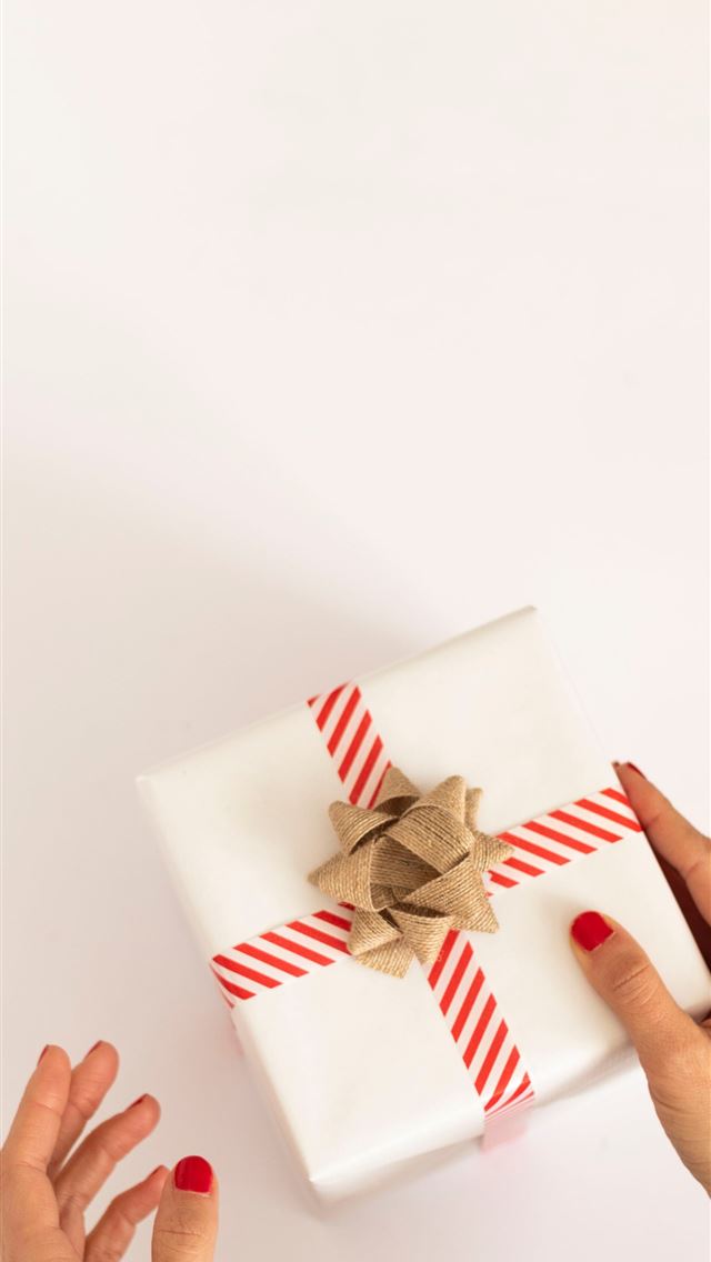 1284x2778 person holding white and red gift box - simple iPhone Wallpaper