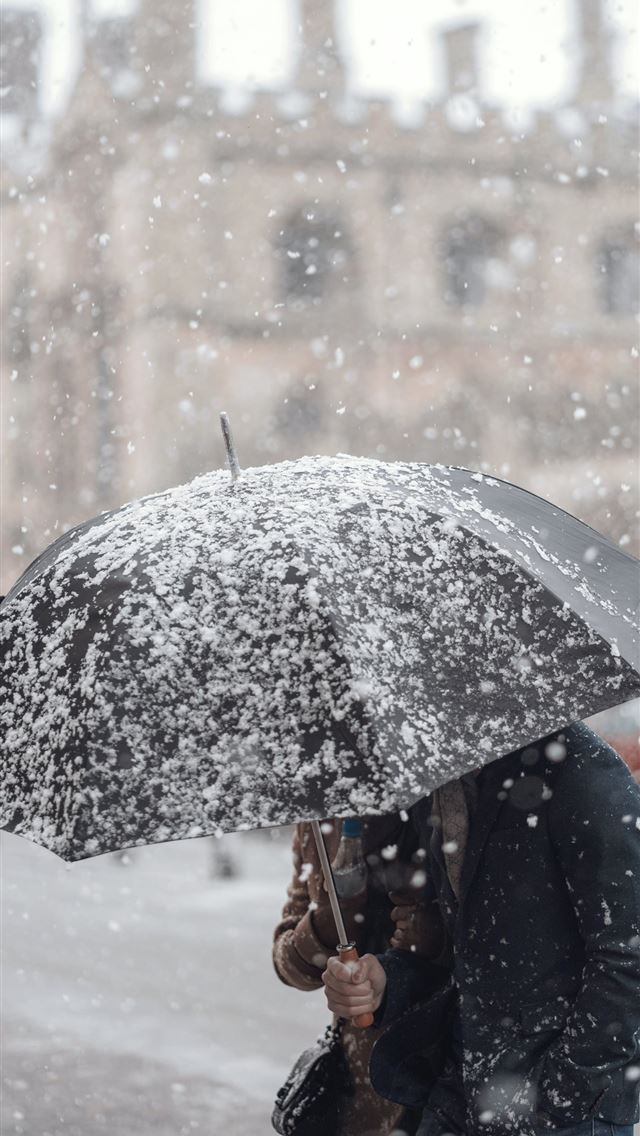 1284x2778 person holding black umbrella - cambridge iPhone Wallpaper