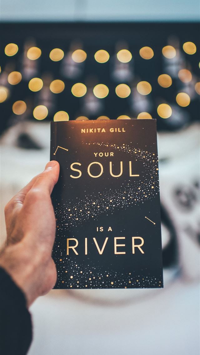 1284x2778 person holding a Your Soul novel book - cover iPhone Wallpaper