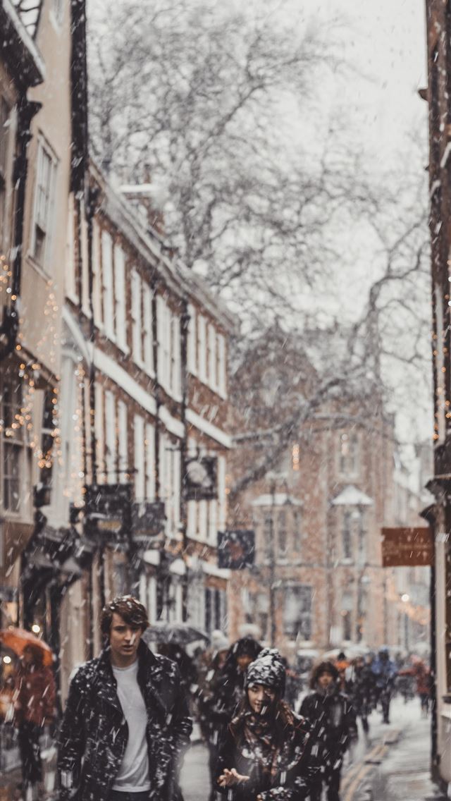 1284x2778 group of people walking near the building - united kingdom iPhone Wallpaper