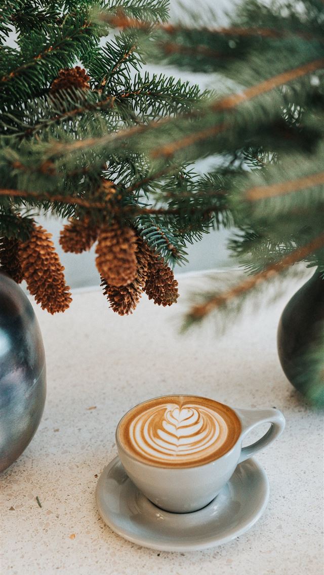 1284x2778 white ceramic coffee mug on saucer in front green ... - los angeles iPhone Wallpaper