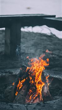 bonfire near bench and sea at daytime wallpaper