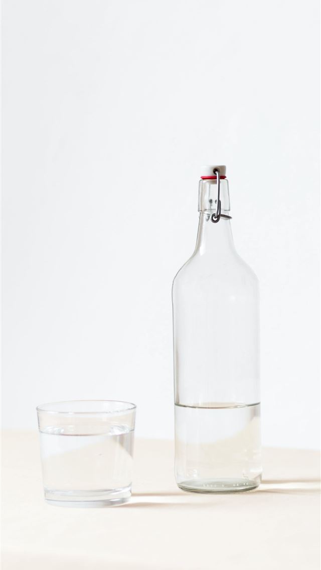640x1136 rocks glass beside half empty bottle on white surf... -  iPhone Wallpaper