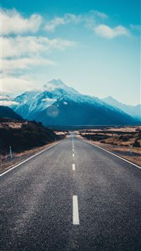 road near mountain during daytime wallpaper