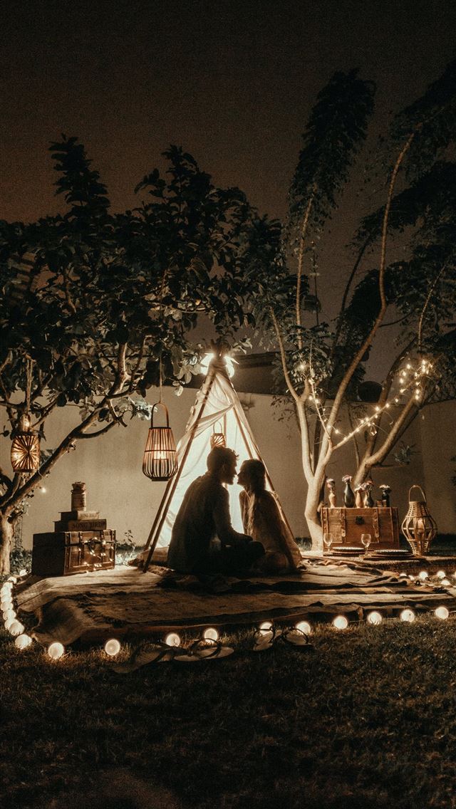 1284x2778 man and woman sitting down on brown carpet near te... - love iPhone Wallpaper