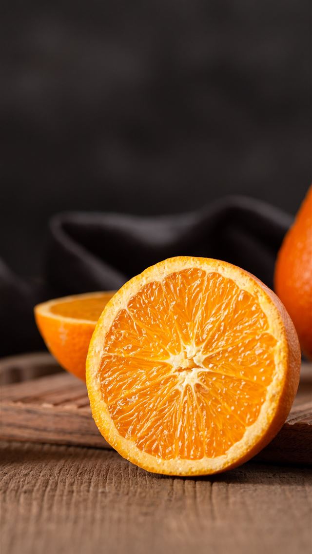 1284x2778 sliced orange fruit on brown wooden table - canada iPhone Wallpaper