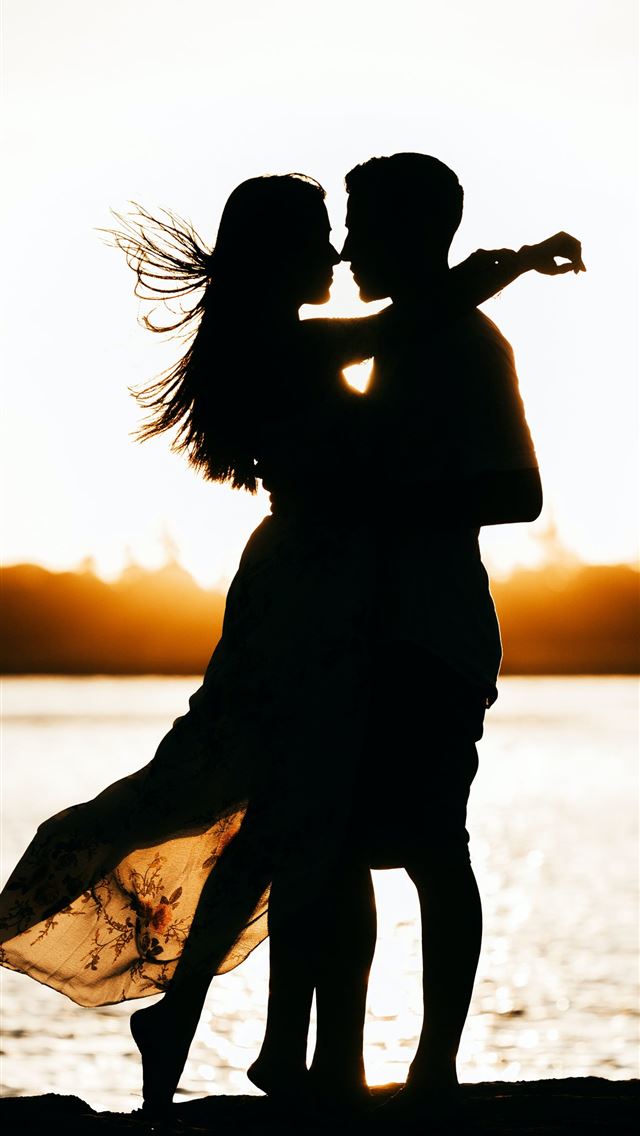 1284x2778 silhouette of woman standing on beach during sunse... - love iPhone Wallpaper