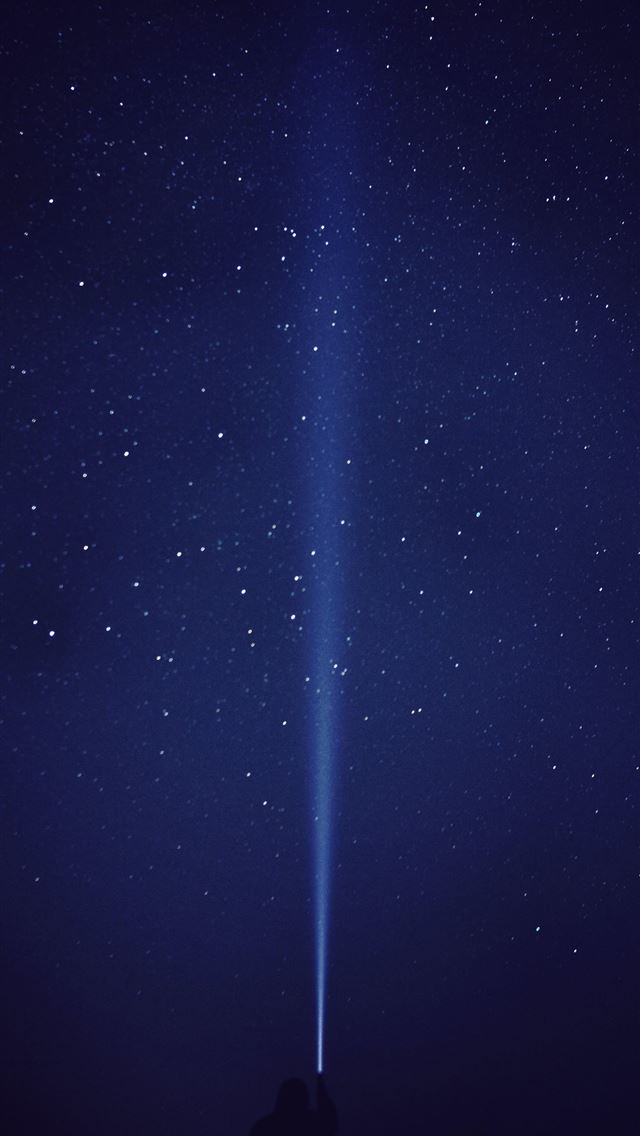 1284x2778 silhouette of person with flash light under starry... - travel iPhone Wallpaper