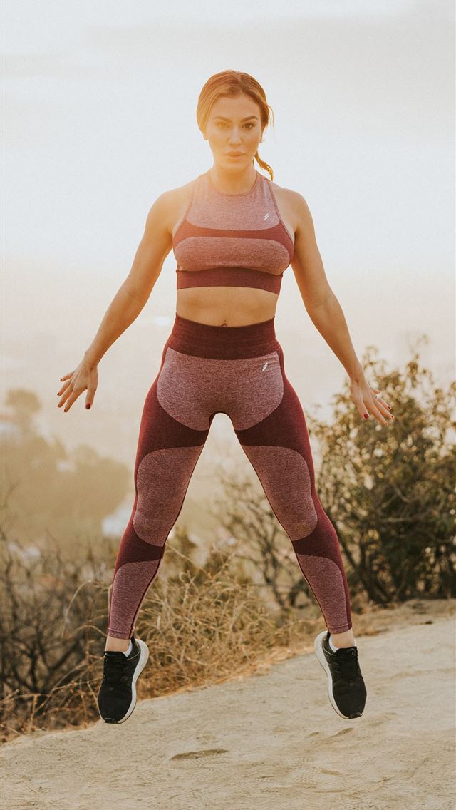 1284x2778 woman jumping above gray sand -  iPhone Wallpaper
