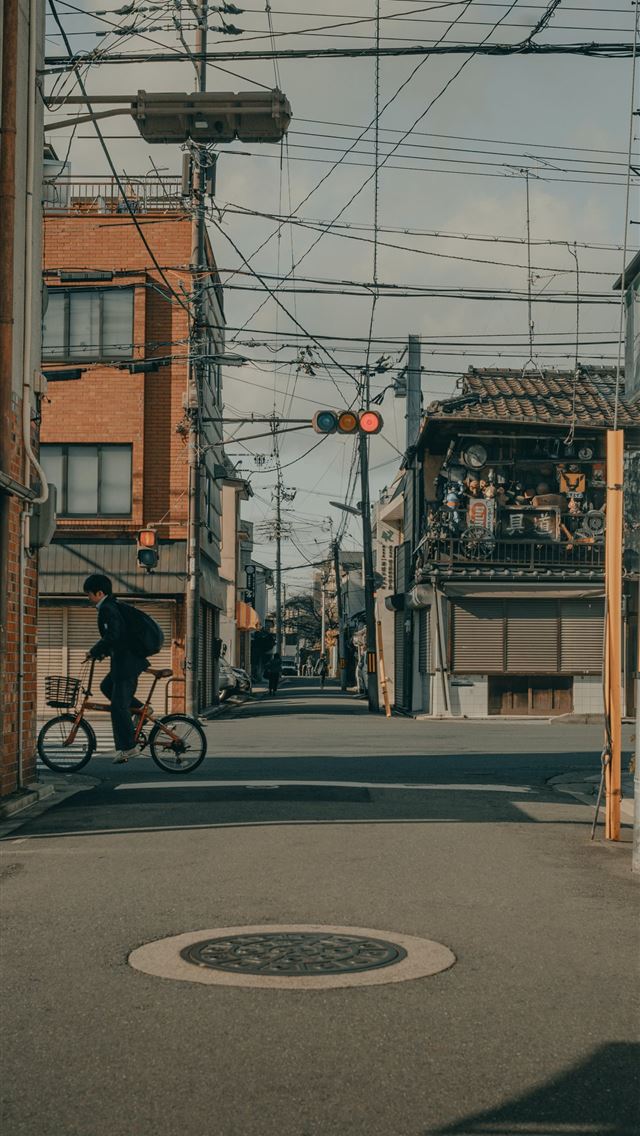 1284x2778 man in black jacket riding bicycle on road during ... -  iphone 13 Wallpaper
