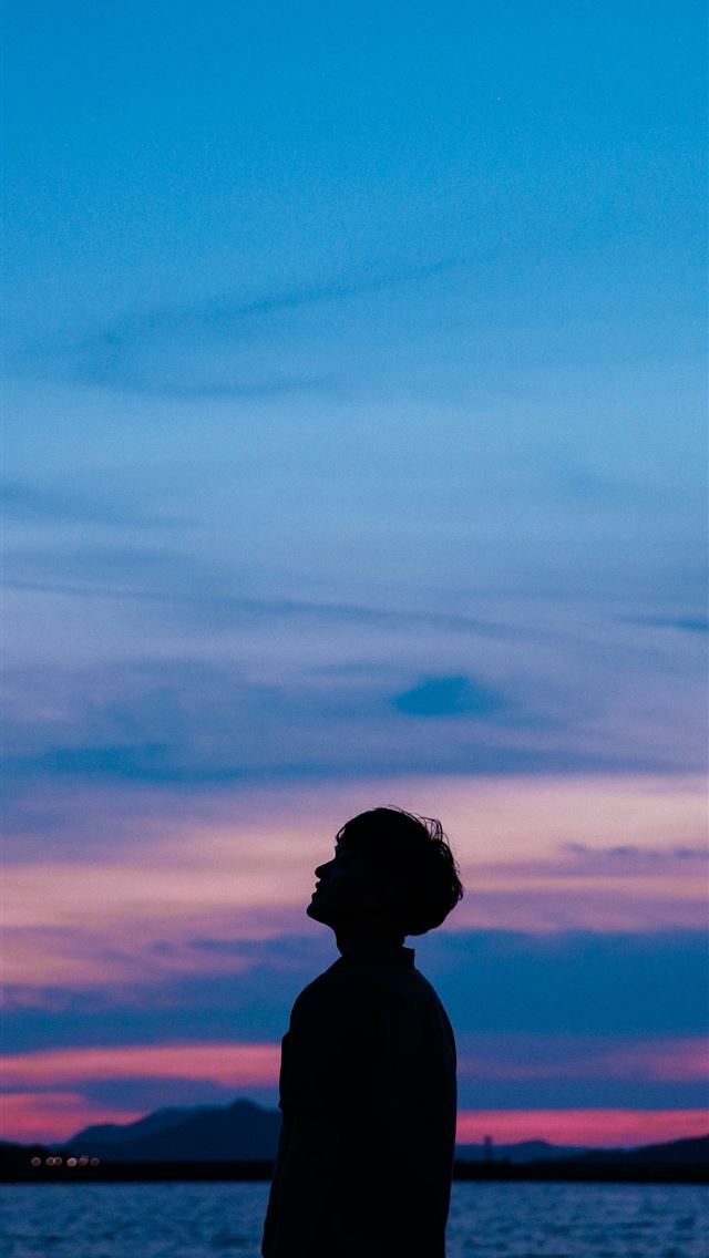 1284x2778 man standing near beach - sky iPhone Wallpaper